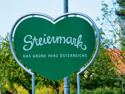 Steiermark, or Styria in Austria. Modern green Traffic warning road sign - heart shape safety construction symbol. Design element. Street blank information concept. Retro Highway. Transportation board