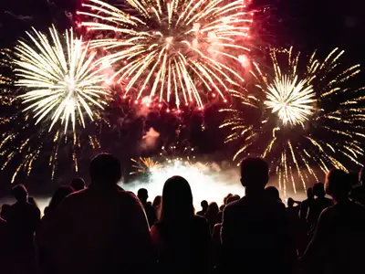 Crowd watching fireworks and celebrating at night