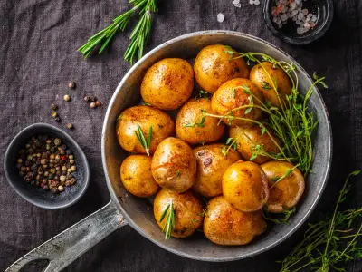 Baked potatoes in a cast iron skillet, top view.