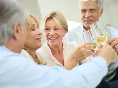 Group of senior people celebrating with champagne