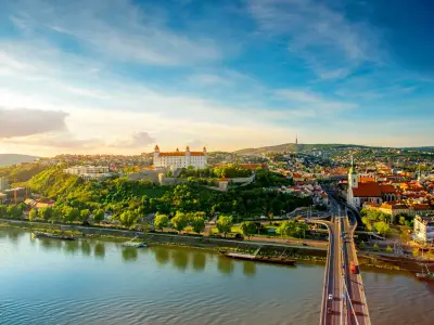 Bratislava aerial cityscape view on the old town with Saint Martin's cathedral, castle hill and Danube river on the sunset in Slovakia. Wide angle view with copy space