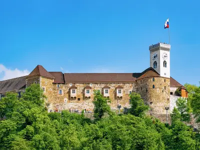 Old castle tower with Slovenian flag at the hill of Ljubljana, Slovenia