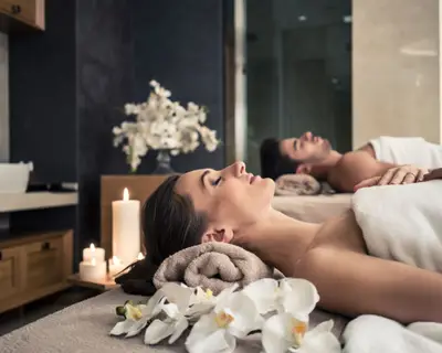 Young man and woman lying down on massage beds at Asian luxury spa and wellness center