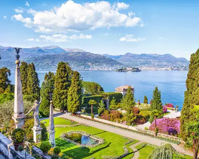 Beautiful Isola Bella island with flower garden on Lake Lago Maggiore in the background of the Alps mountains, Stresa, Italy