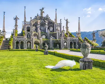 Beautiful Isola Bella island with flower garden, white peacocks and baroque statues, Lake Maggiore, Stresa, Italy.