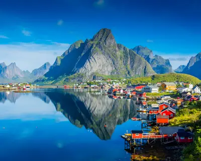 Perfect reflection of the Reine village on the water of the fjord in the Lofoten Islands, Norway