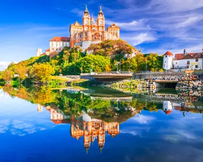 Melk Abbey, Austria. Stift Melk reflected in the water of Danube River, scenic Wachau Valley autumn sunny day.