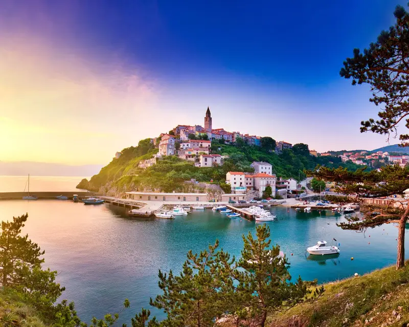 Town of Vrbnik (Verbnik) harbor view morning glow, Island of Krk, Kvarner bay archipelago, Croatia, Europe. Dramatic summer seascape of Adriatic sea. Stone beach. Incredible morning cityscape.